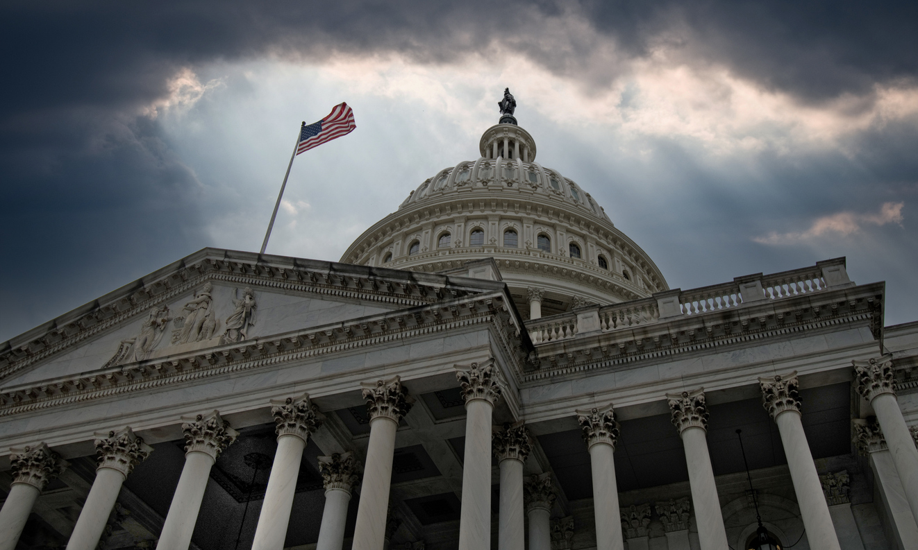 U.S. Capitol building with American flag, symbolising the 2025 government shutdown and its impact on immigration services such as USCIS, DOL, and E-Verify
