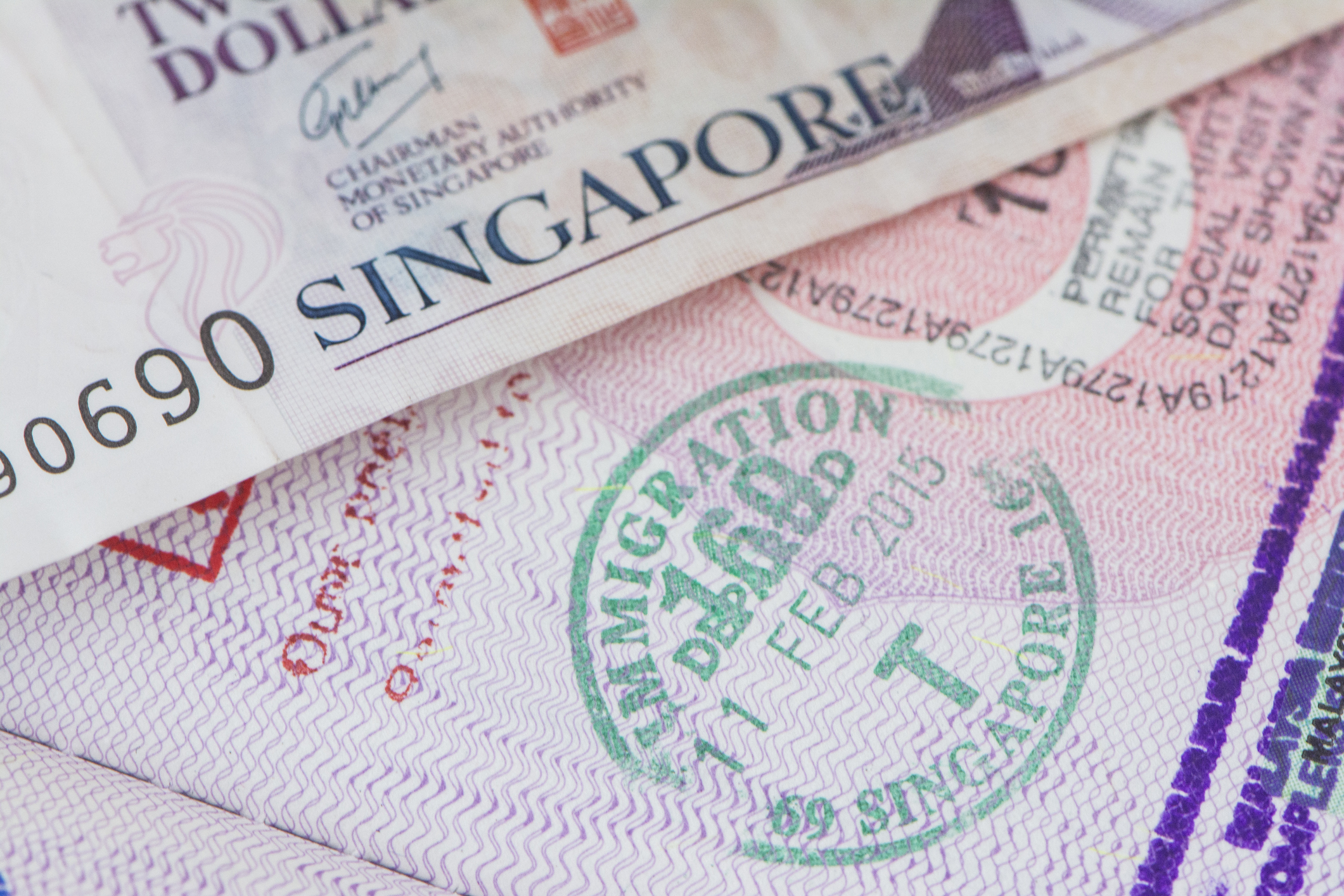 Singapore immigration entry stamp on passport document