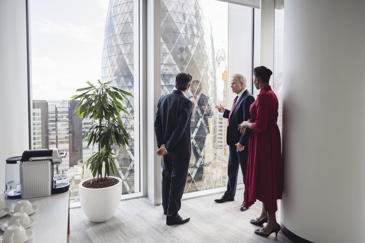 Overseas business professionals reviewing UK expansion plans in a London office