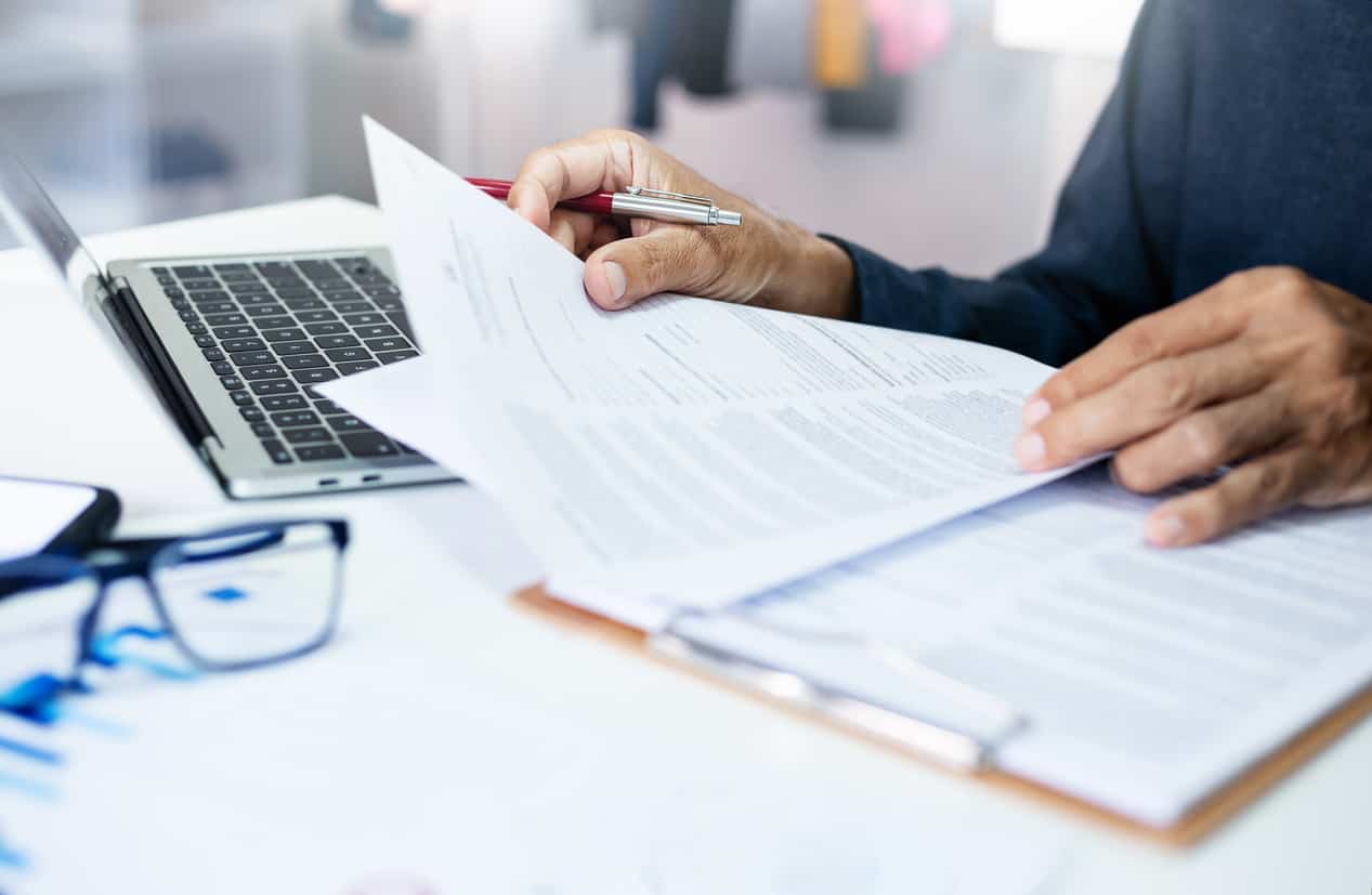 Business professional reviewing documents for sponsor licence compliance and audit preparation