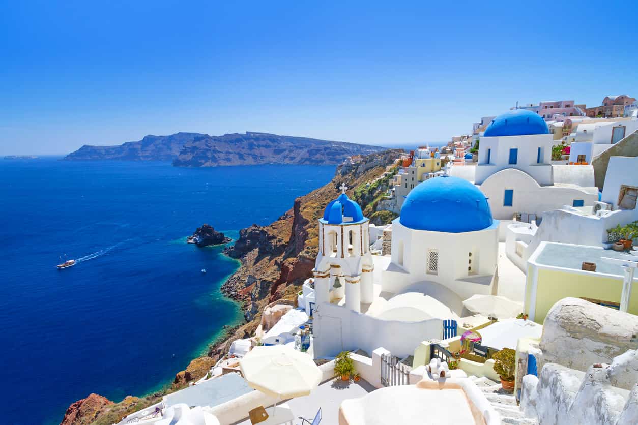 Greece visa and immigration services with Santorini coastline background