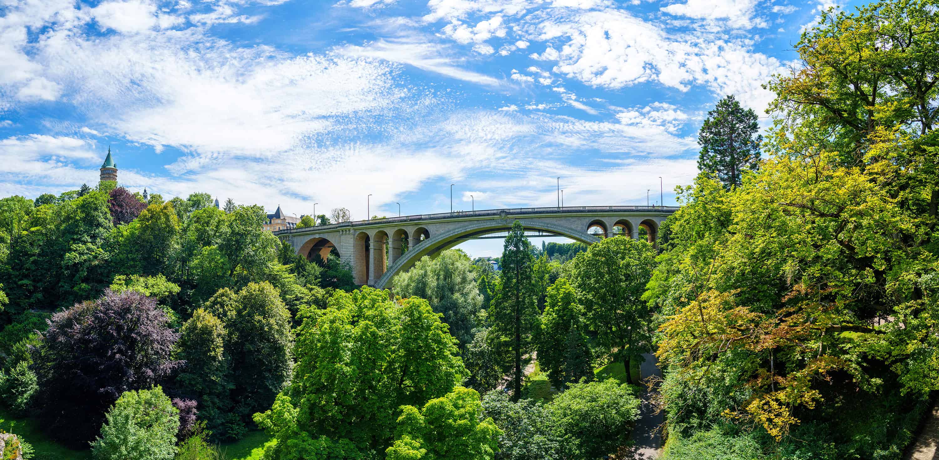 Stone arch bridge above a wooded valley in Luxembourg City.