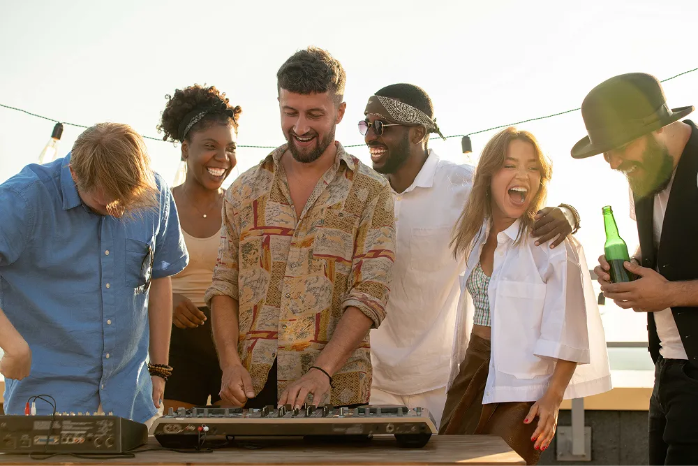 Laughing multiethnic friends enjoying rooftop party