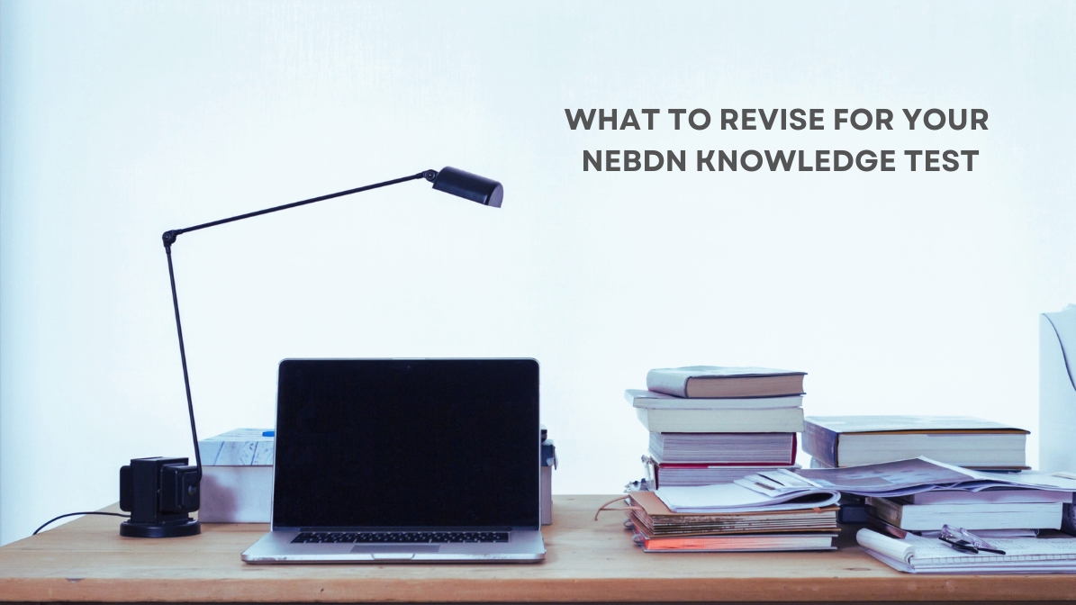 Study desk with laptop and books for NEBDN Level 3 Dental Nursing Knowledge Test revision