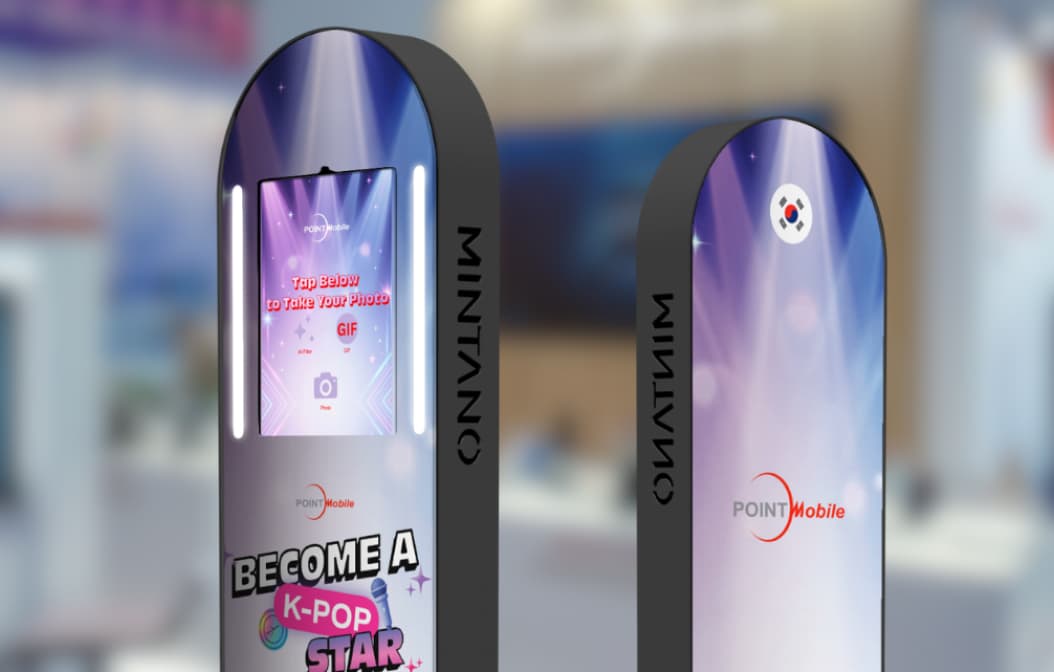 Two MINTANO OneMax photo booths in Point Mobile design in front of a trade fair booth.