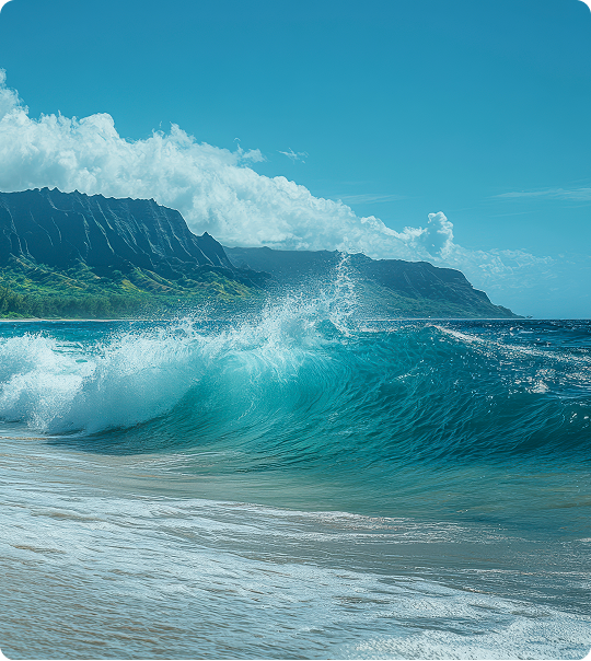 Blue ocean wave crashing near a sandy shore with mountainous coastline and cloudy sky in the background.