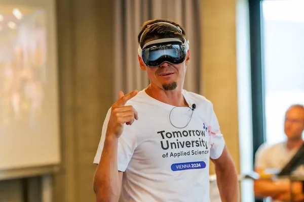 Christian Rebernik wearing Apple Vision Pro headset during an interactive session at Tomorrow University, showcasing innovative technology in modern education.