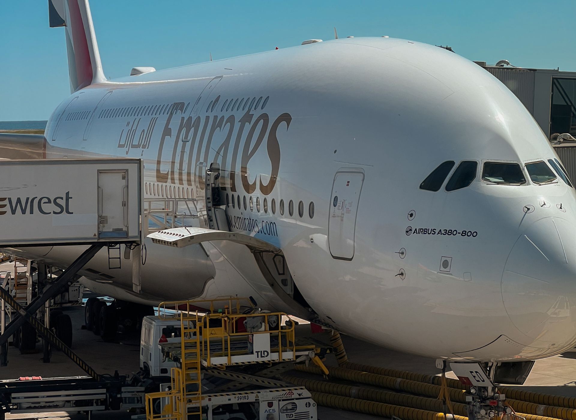 Emirates Airbus A380-800 being prepared on the tarmac before takeoff.