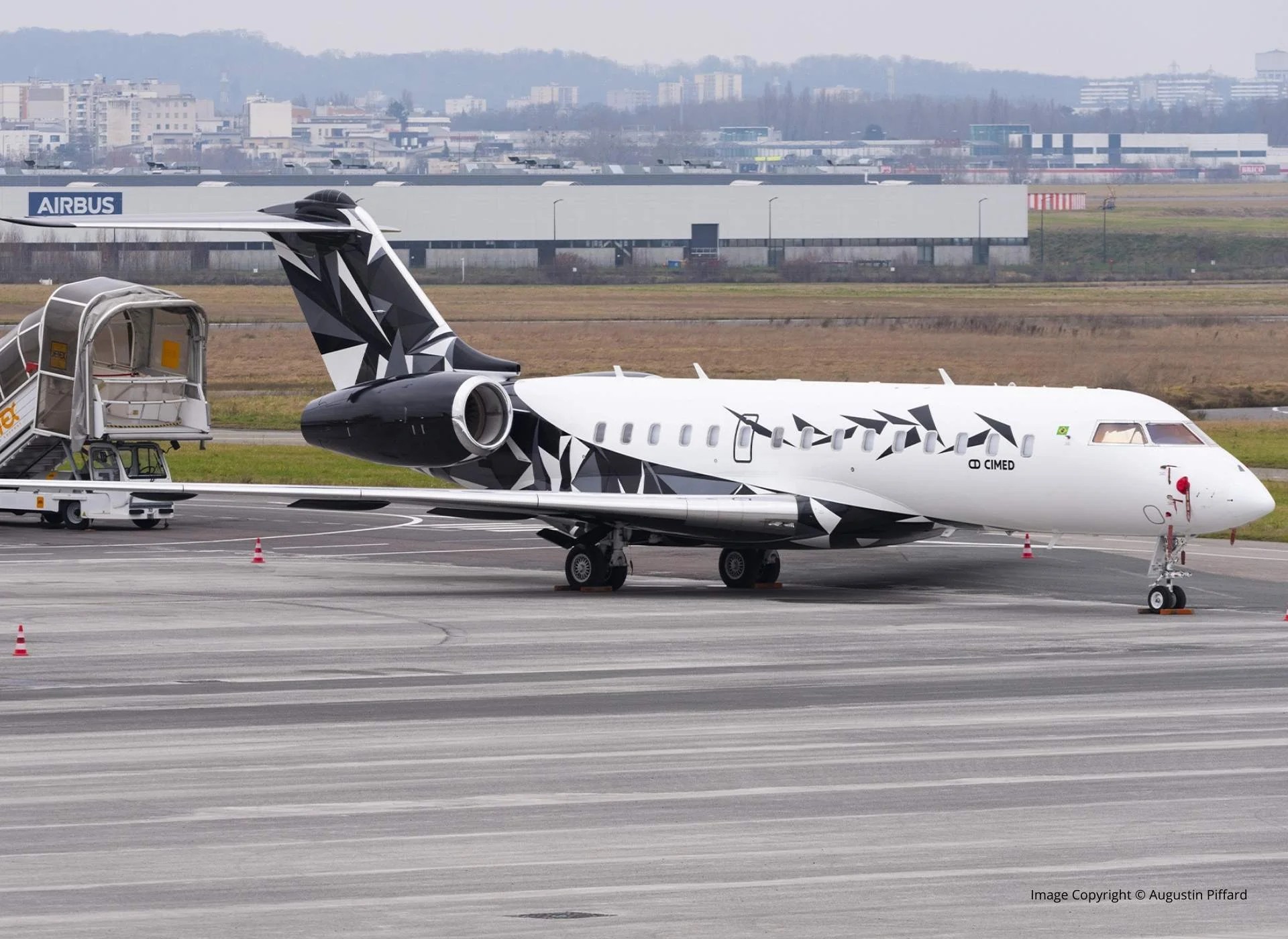 Bombardier Global 6000 private jet on the tarmac, side view, business aviation aircraft at airport.