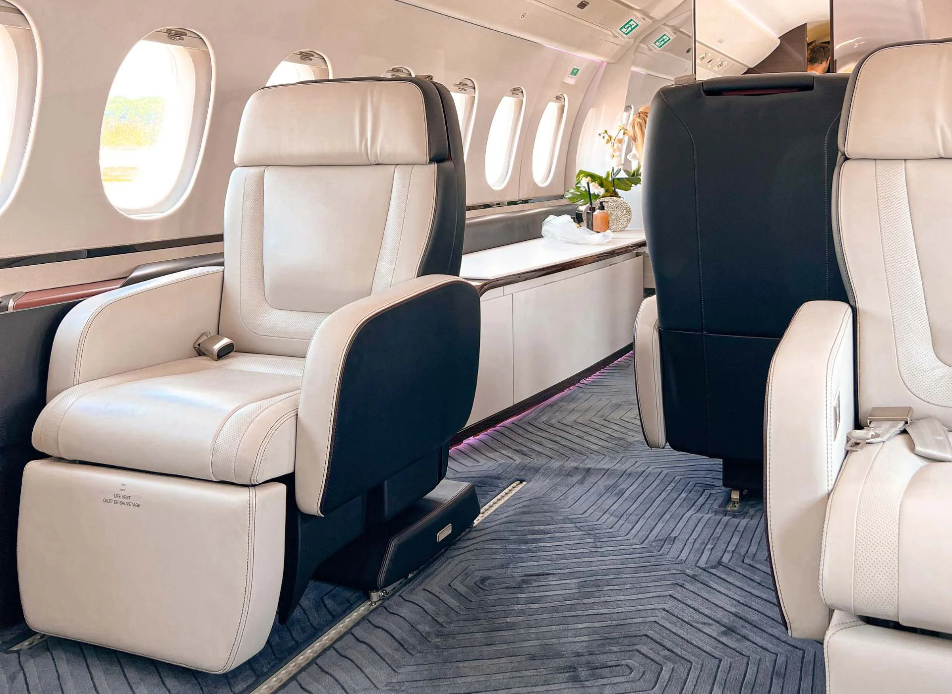 Dassault Falcon 6X private jet interior with spacious leather seats and wide cabin layout designed for long-haul comfort