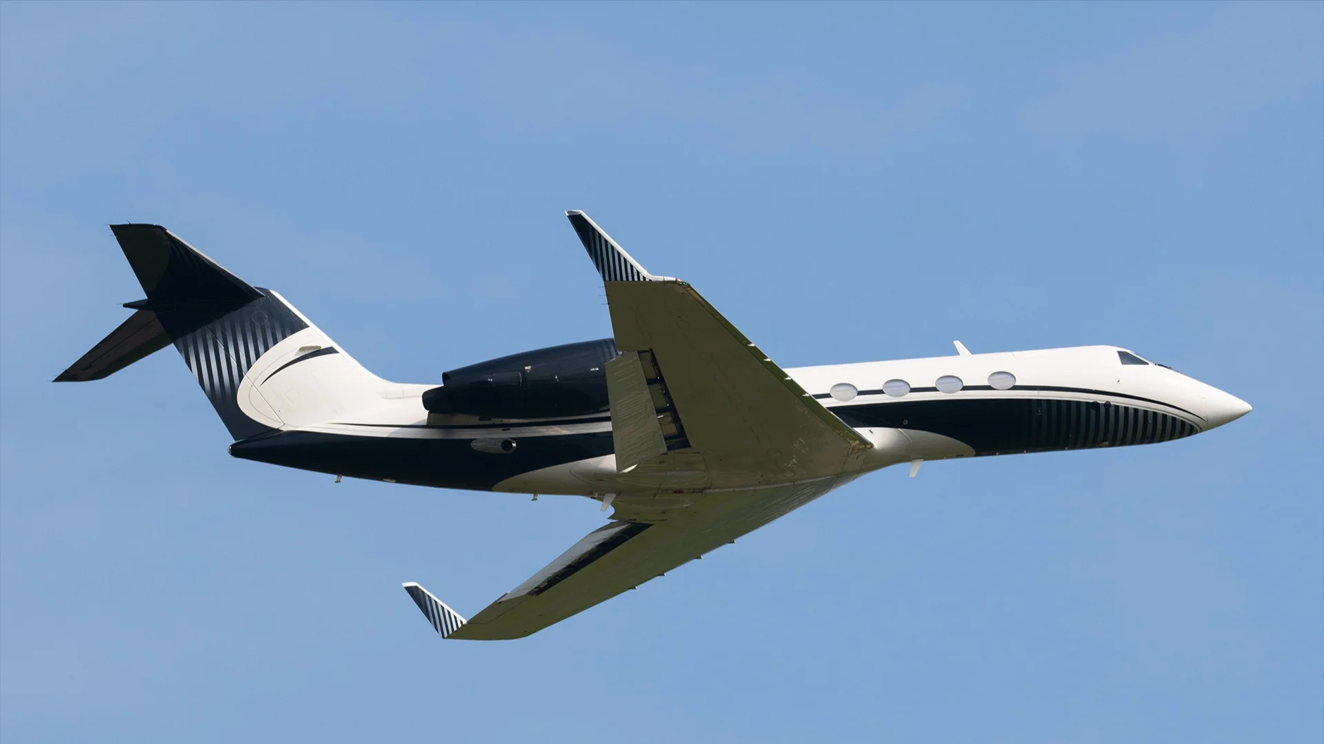 A white private jet from Gulfstream manufacturer taking off 