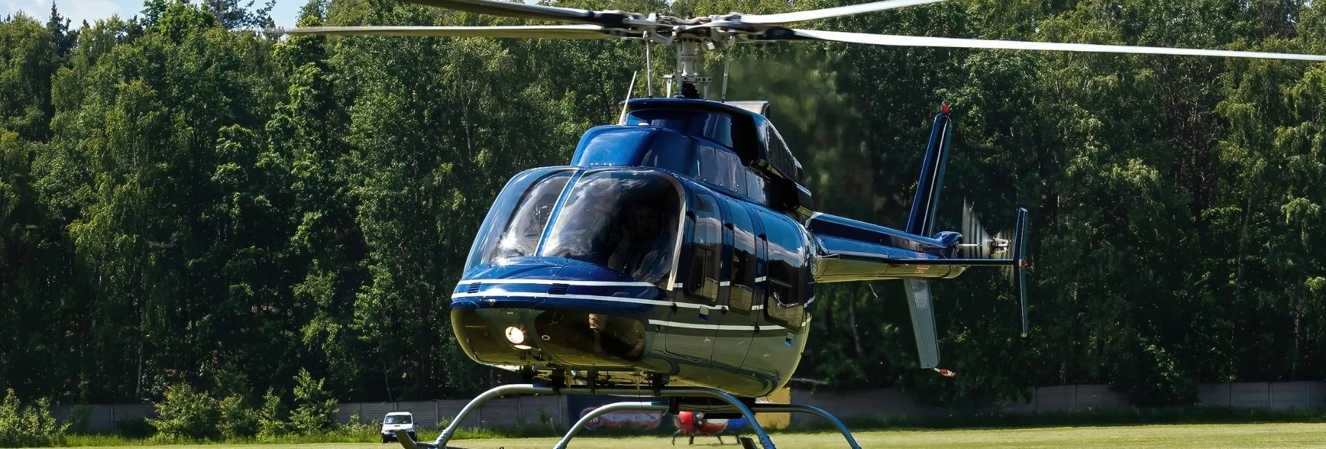 Blue private helicopter on the ground ready for takeoff to Ascot