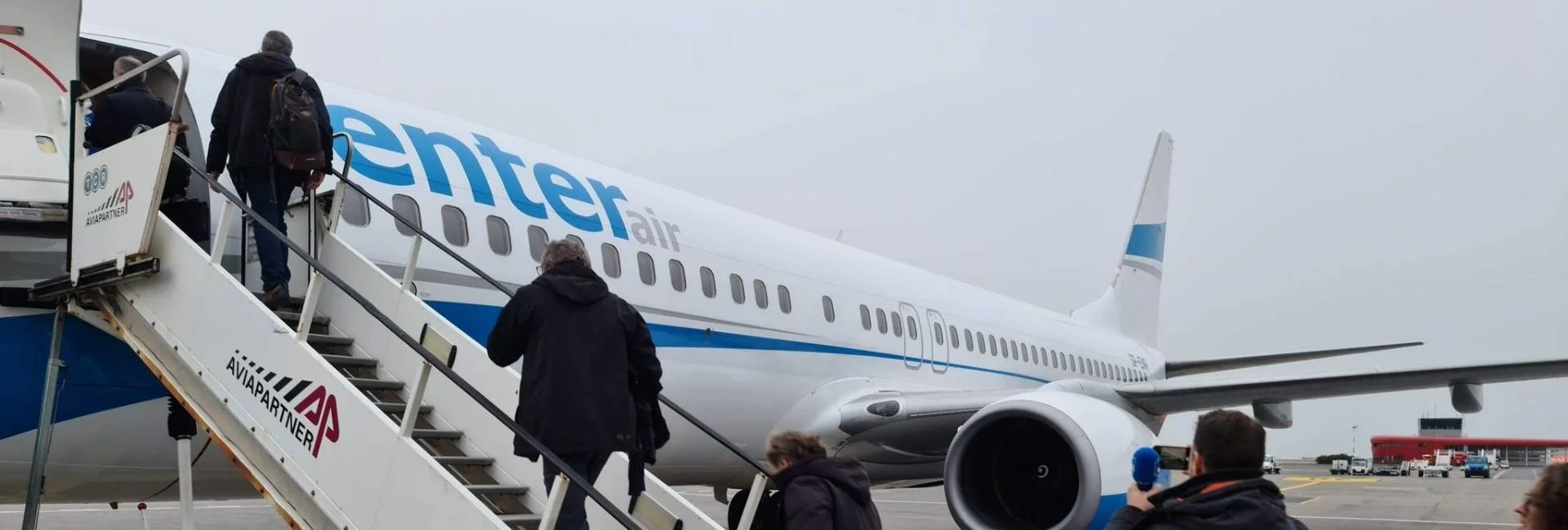 Passengers boarding aircraft to attend an international tennis event
