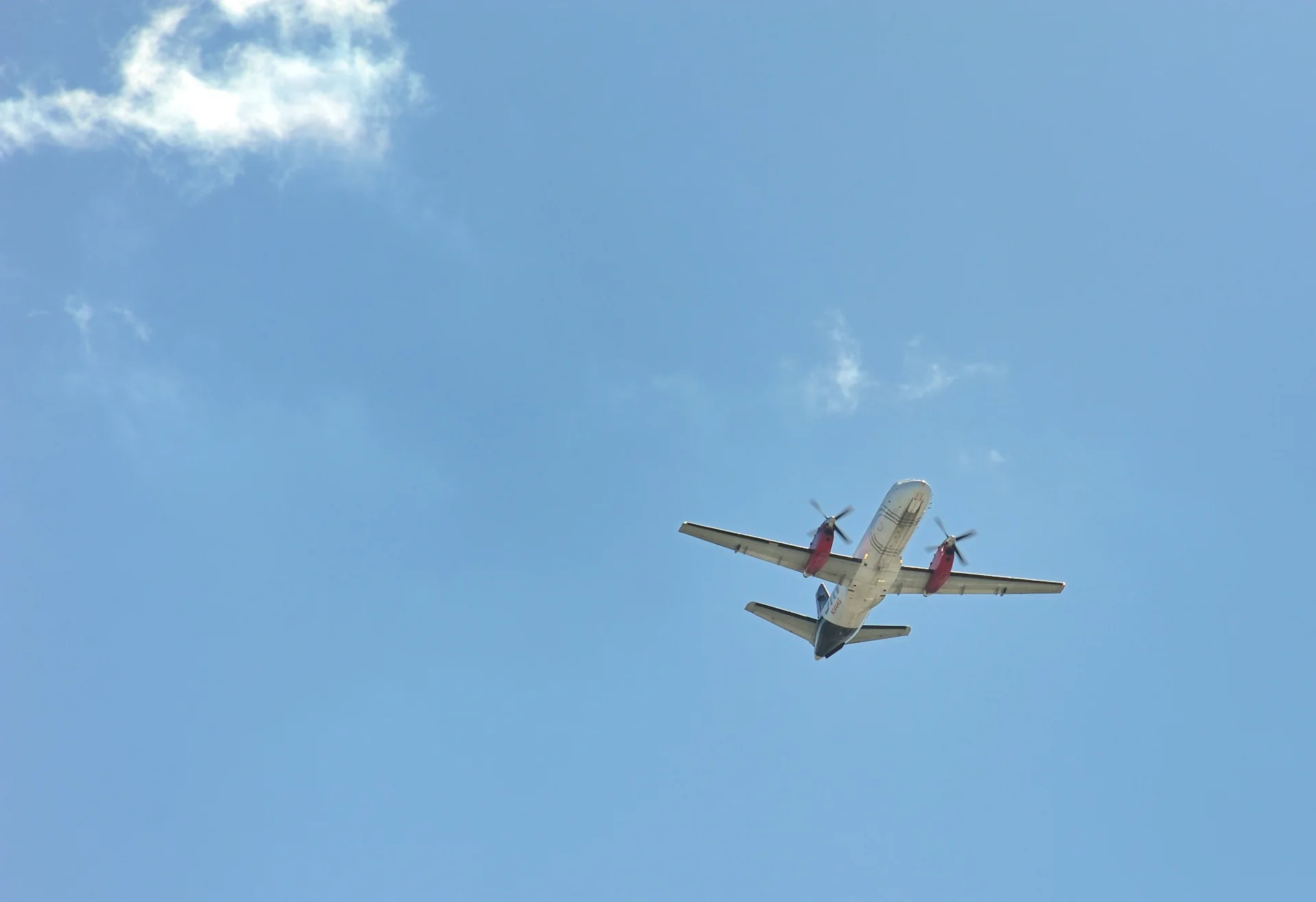 Underside view of a Saab 340 turboprop aircraft in flight