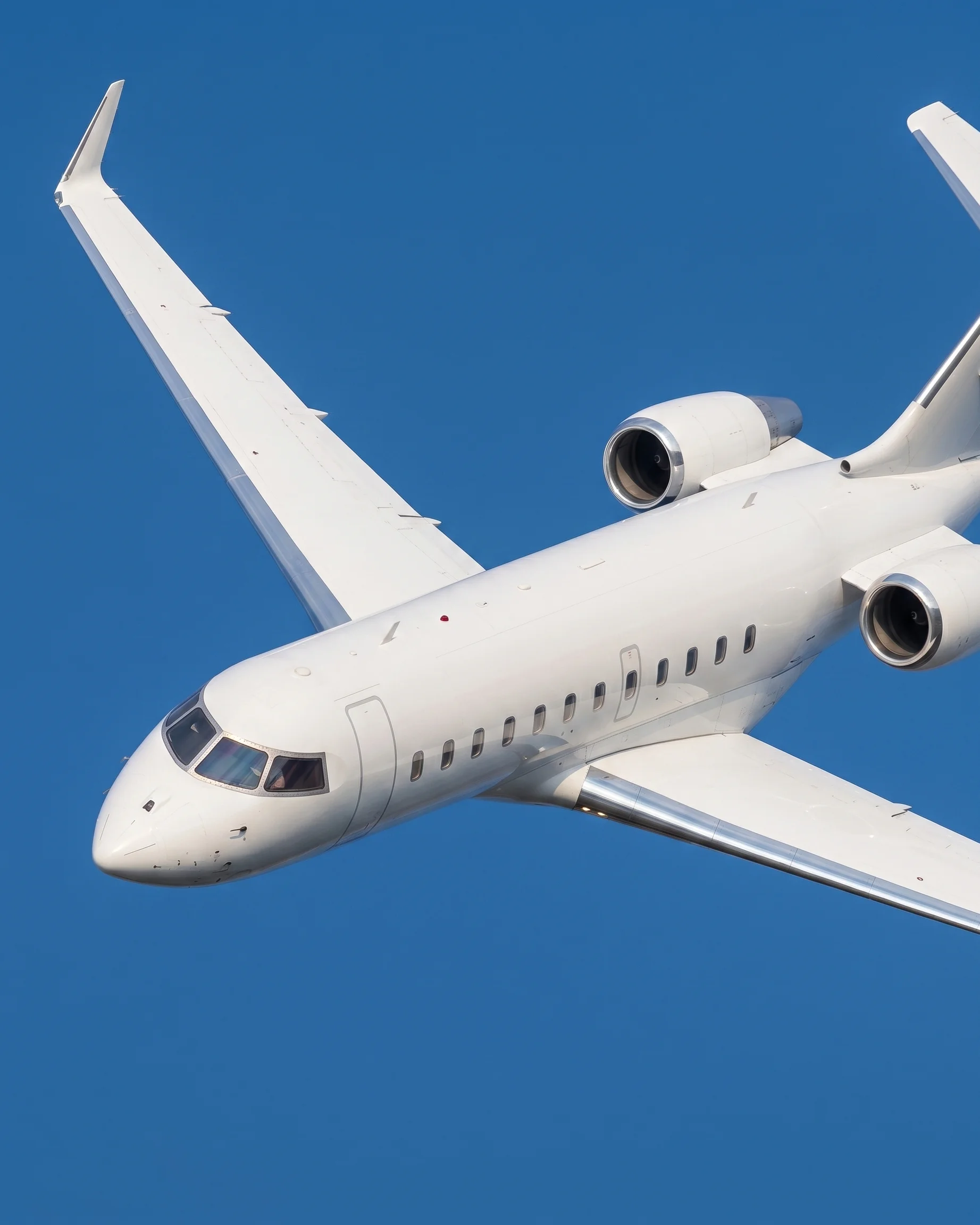 Front angle view of a CRJ200 aircraft climbing against a blue sky