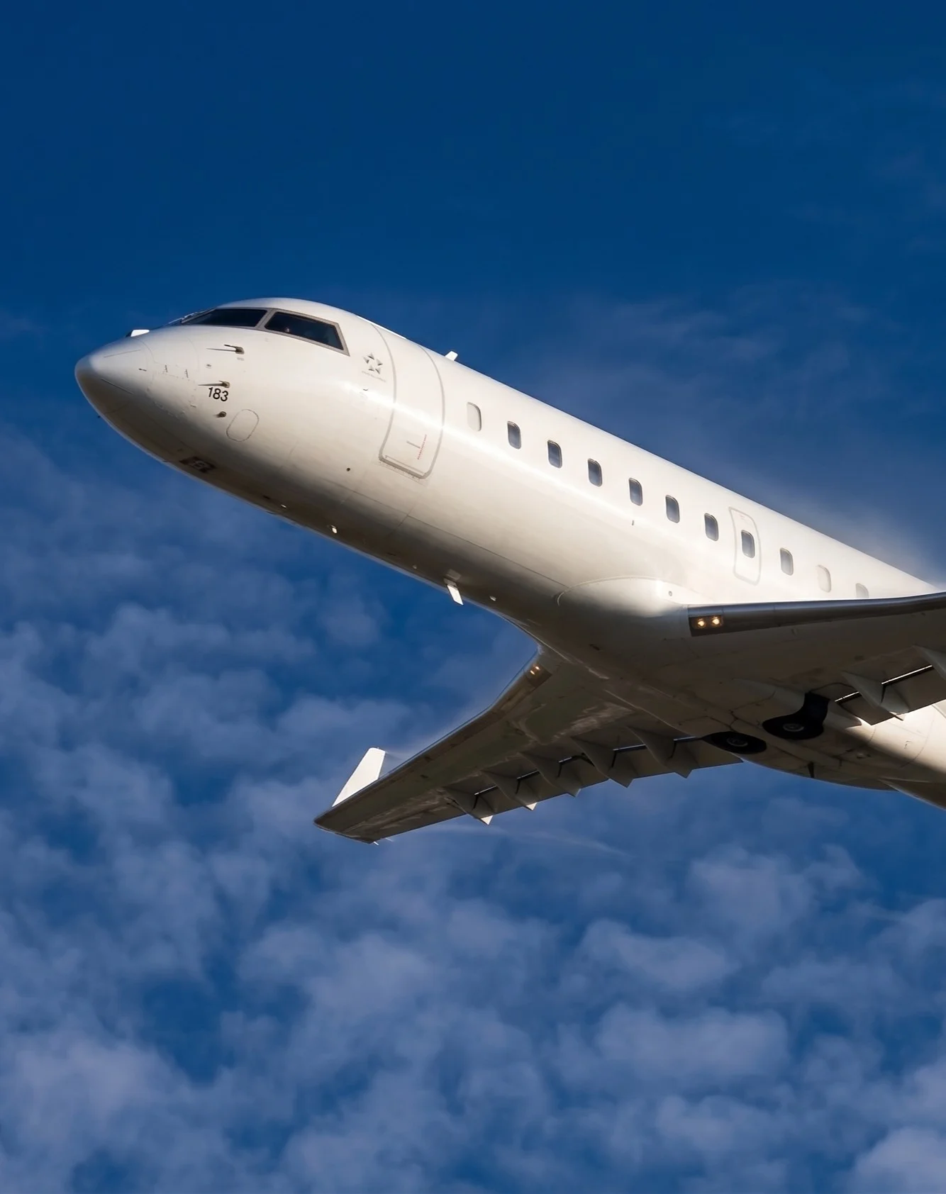 CRJ200 aircraft climbing through clouds, showing the Star Alliance logo on the nose