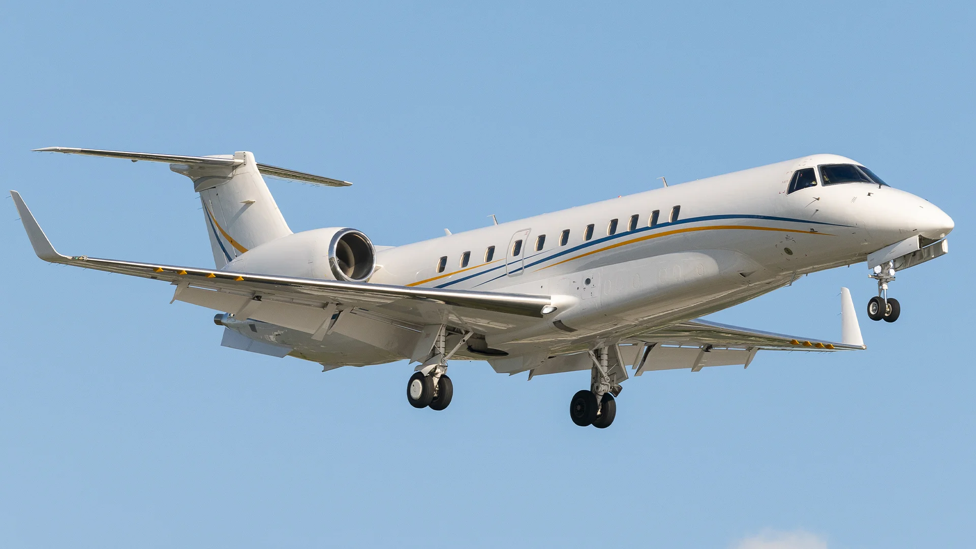 ERJ135 aircraft landing against a clear blue sky