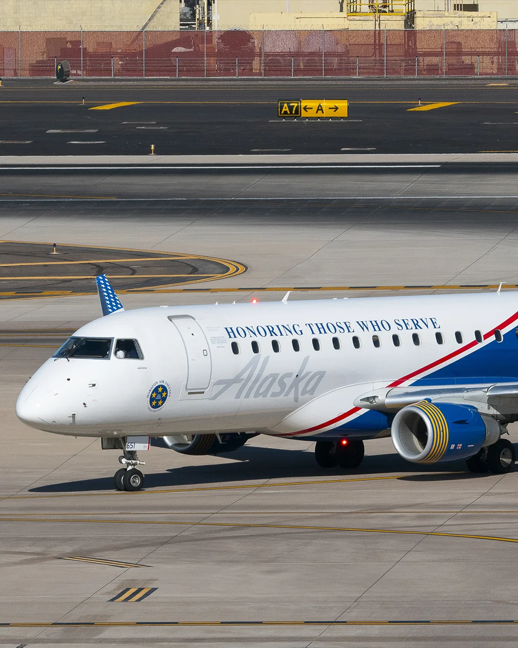 Front view of an Embraer ERJ170 aircraft in Alaska Airlines special livery honoring service members