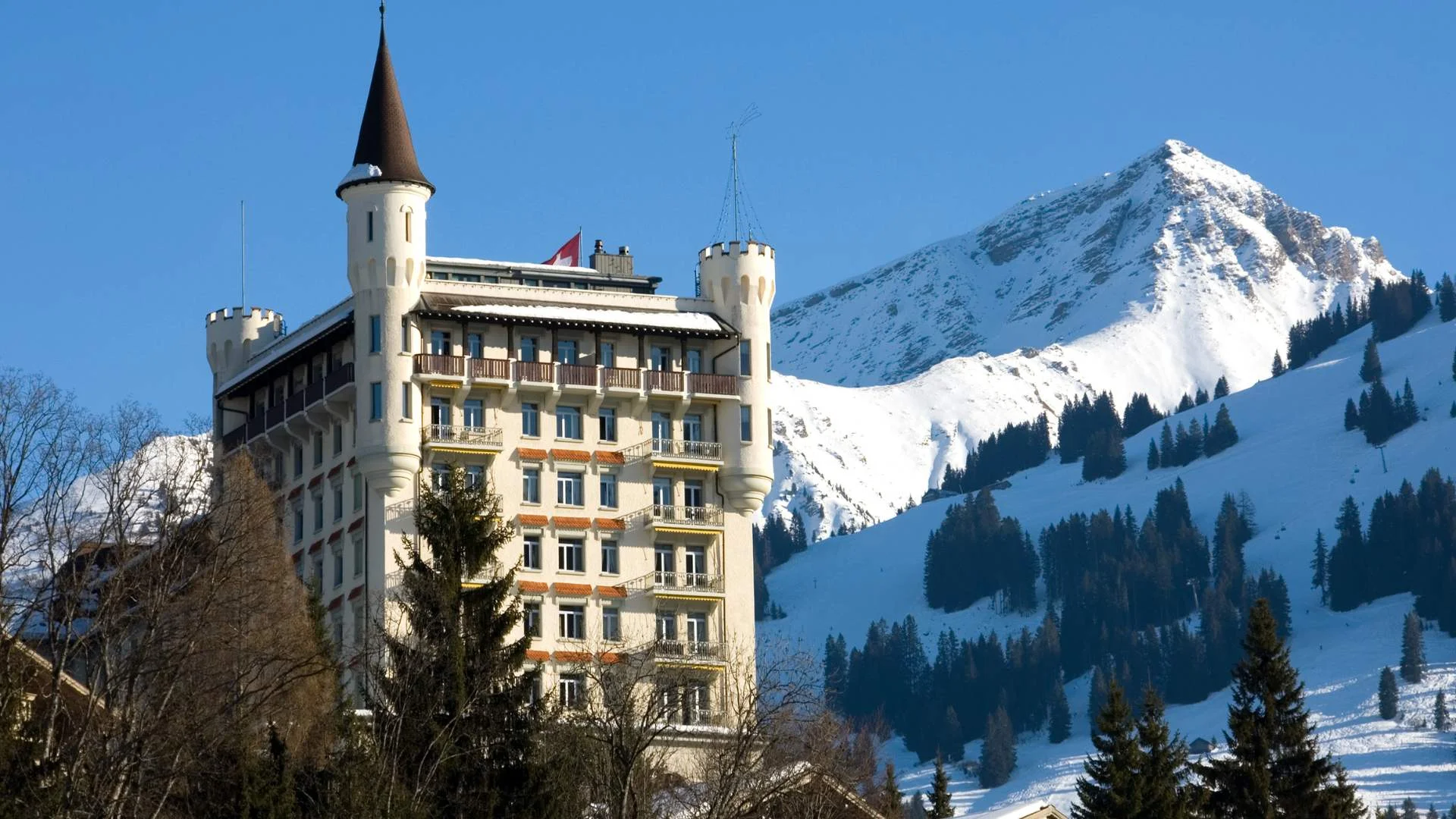 Gstaad Palace and snow-covered mountains