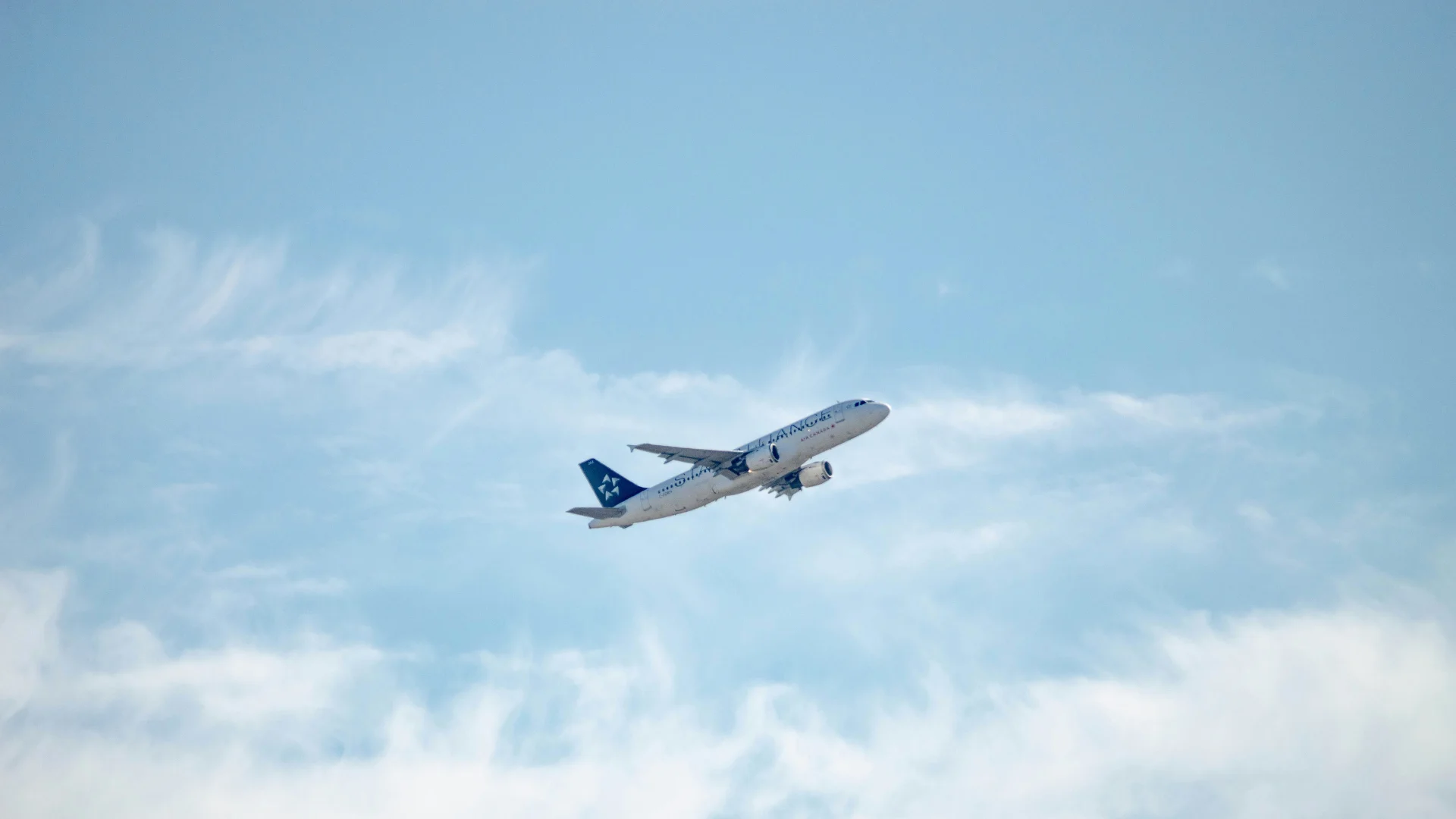 Passenger aircraft taking off into a blue sky