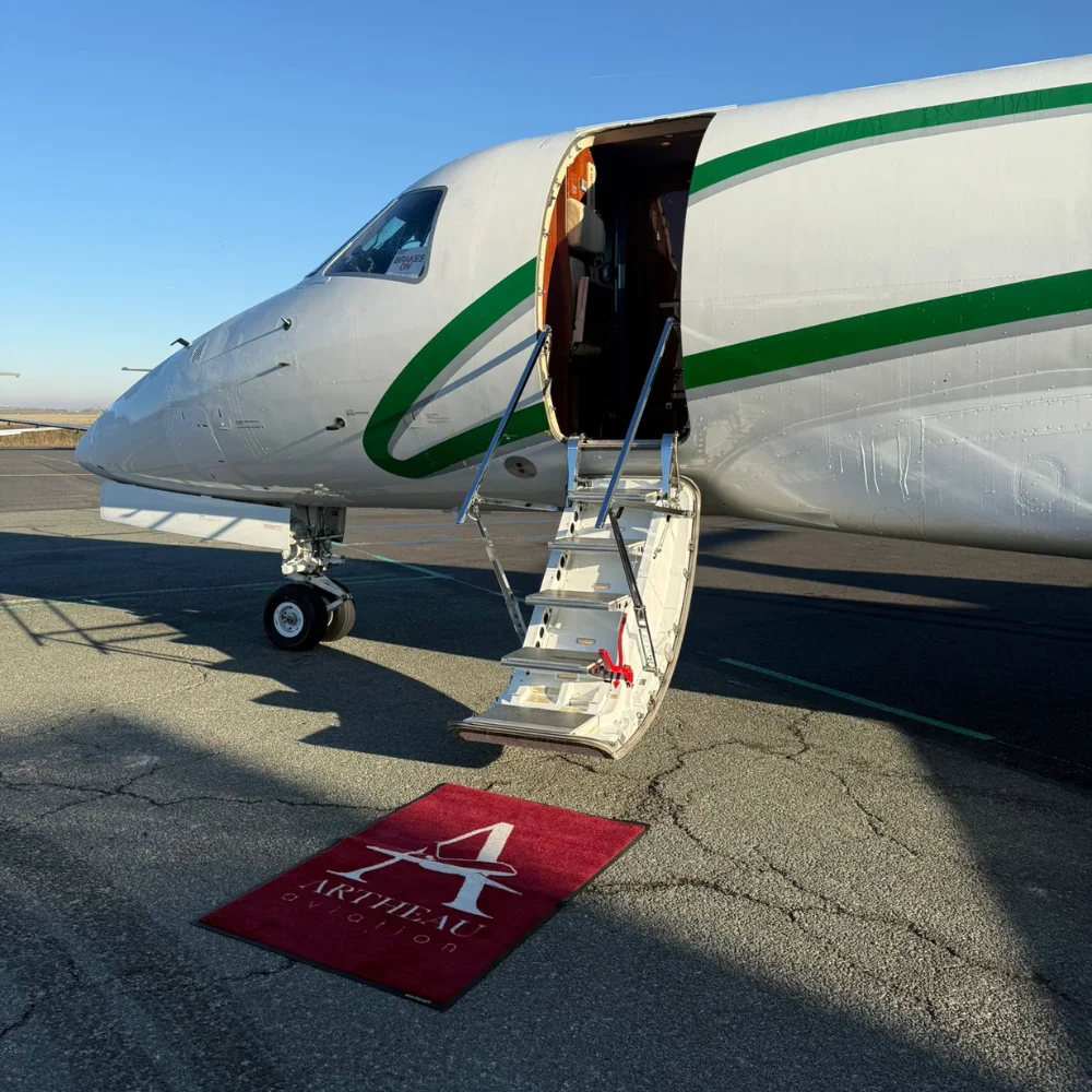 Private jet with stairs down and Artheau Aviation carpet