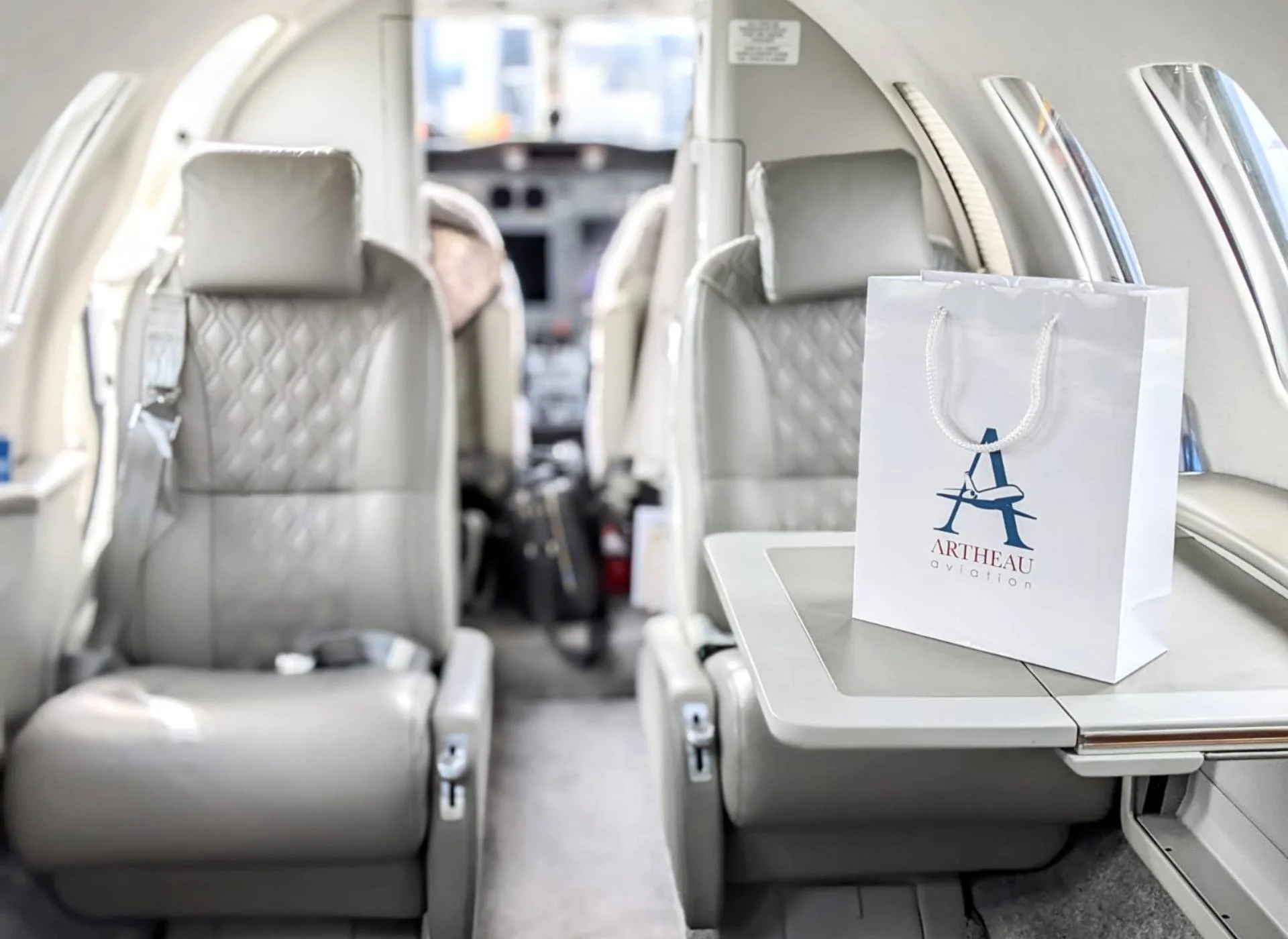 Cessna Citation CJ2 private jet cabin with leather seats and an Artheau Aviation bag