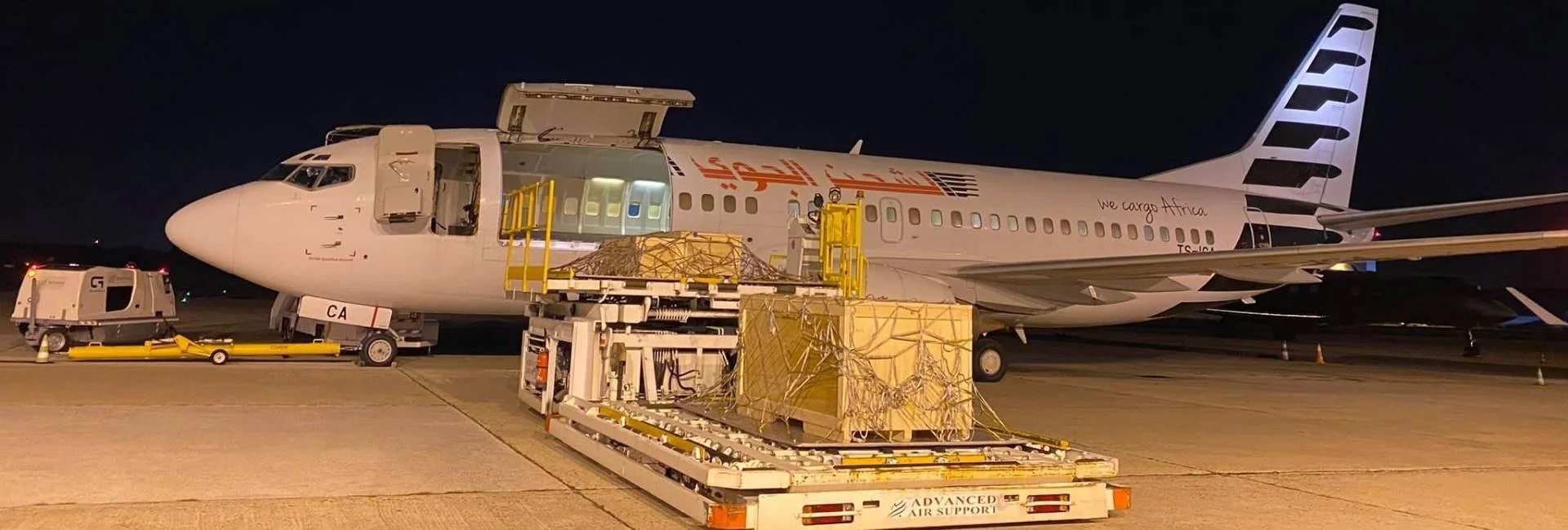 Boeing 737 cargo aircraft loading cargo at night