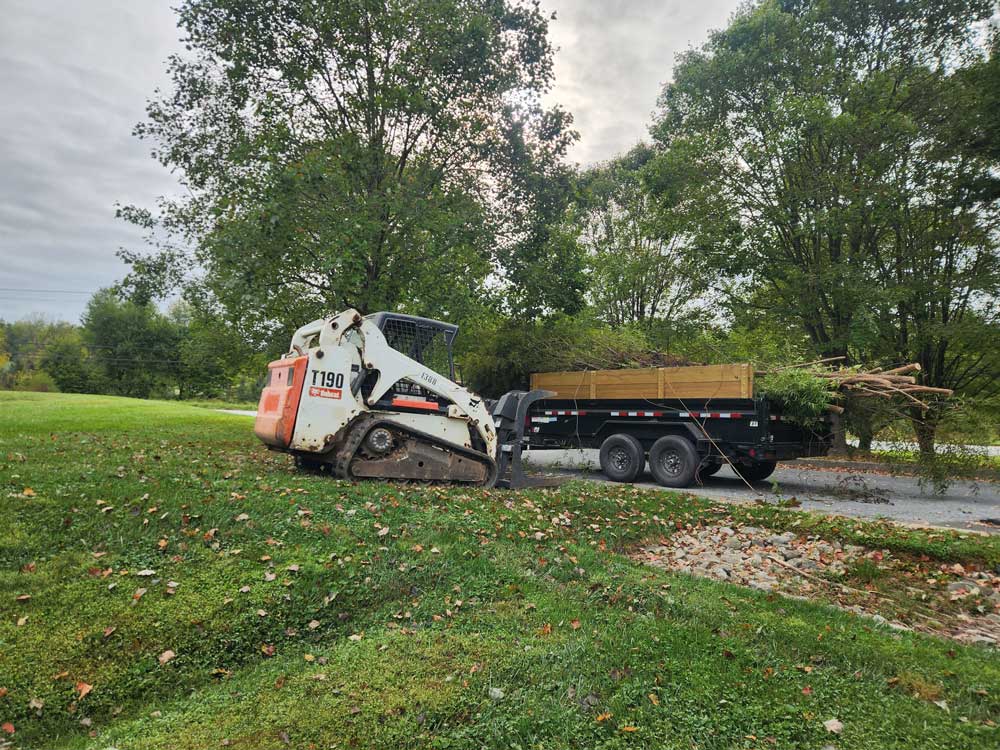 a large machine lifting materials onto a truck bed