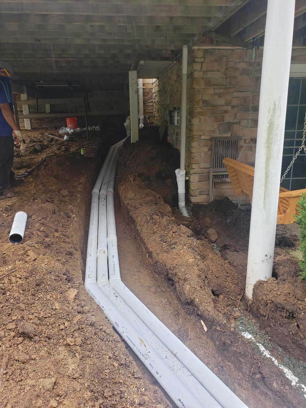 an image of multiple drainage pipes laid in the ground