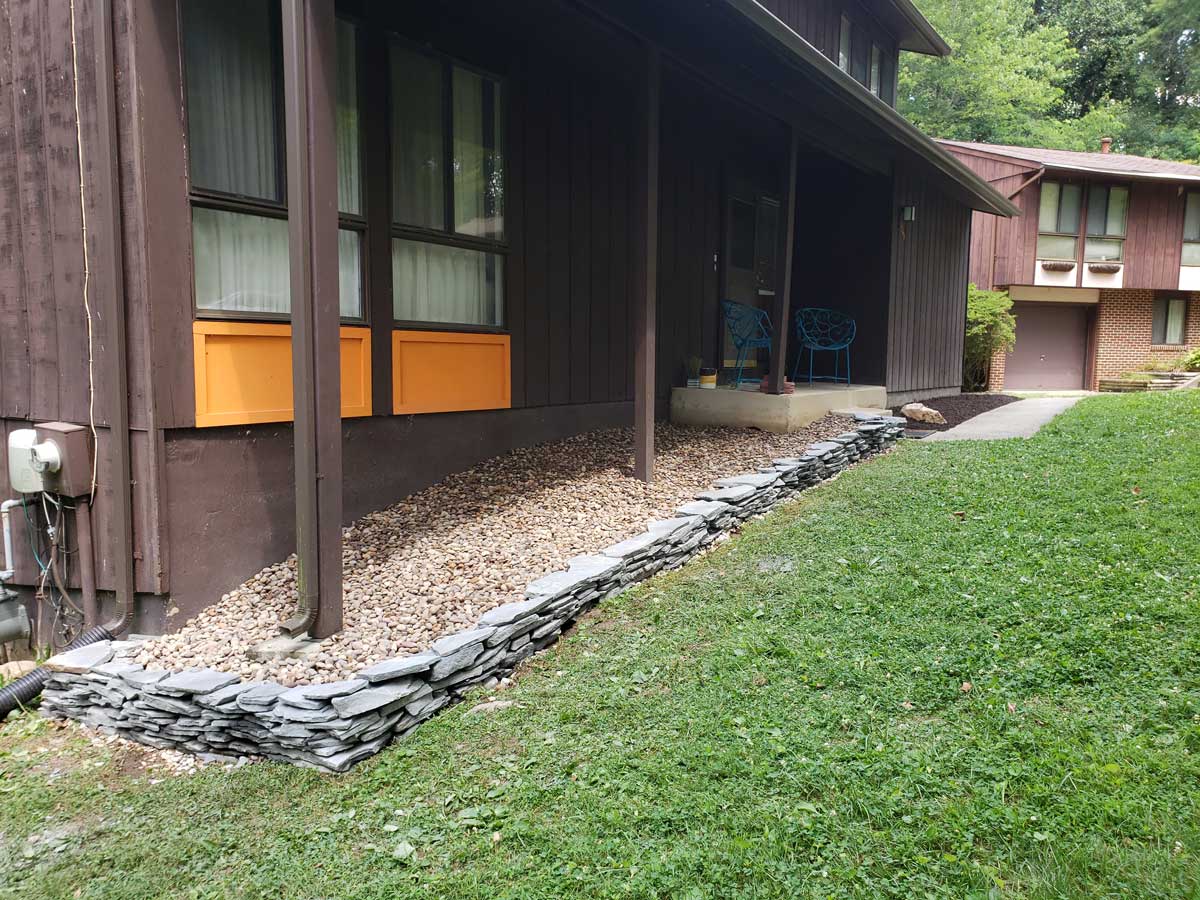 flower bed with stones along the edge