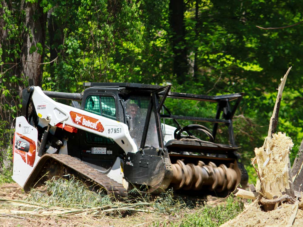 A forestry mulcher operated by Trevor Hubbard is mulching trees and clearing land in Woodbine, MD.