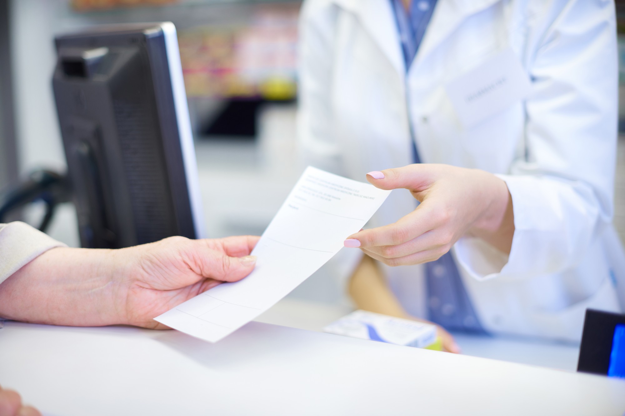 a pharmacist giving patient a prescription