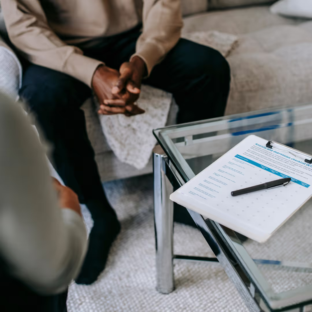 Image of a man sitting in a therapy session