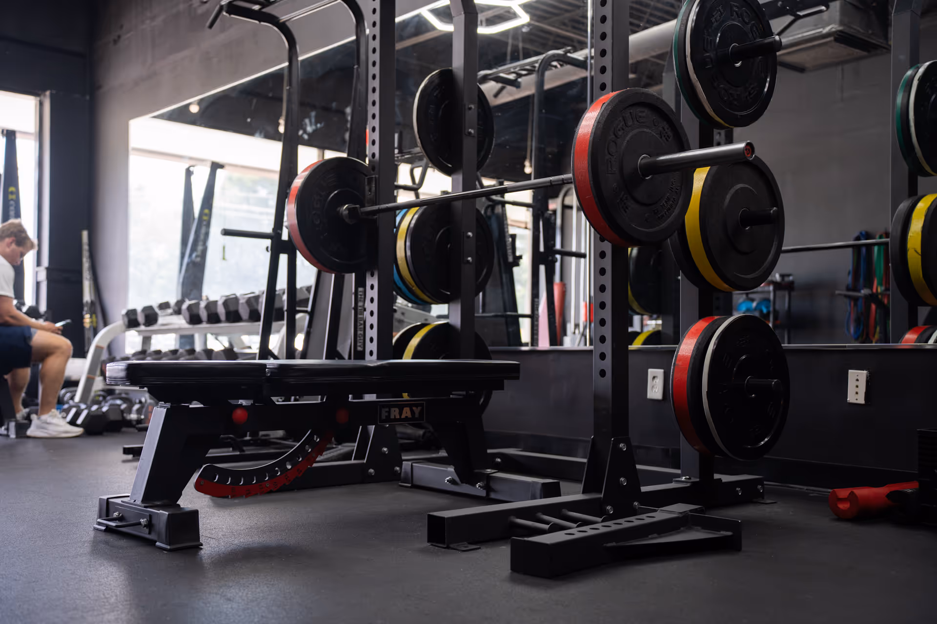 A man lifting a barbell at Sanctuary Strength gym membership