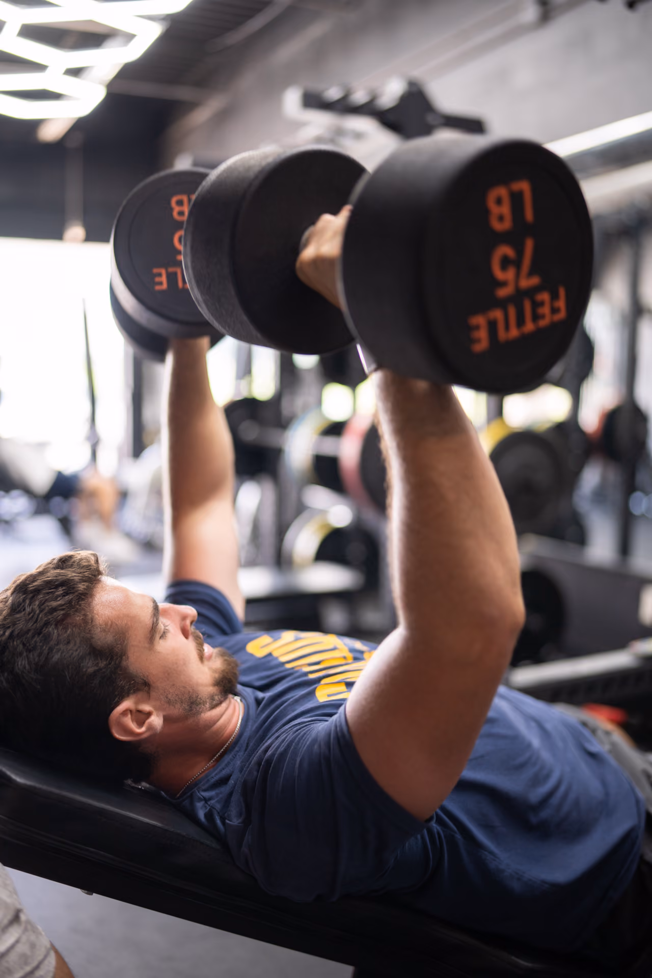 A member doing an incline press with 75 lb dumbbells at Sanctuary Strength, a 24-hour gym in Franklin, TN