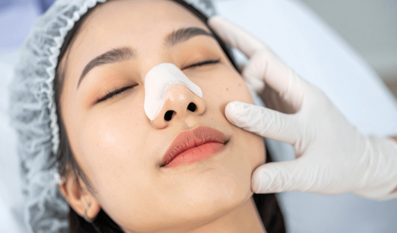 A woman lies in the doctor’s office with a bandage on the bridge of her nose after undergoing a surgical procedure to improve breathing in Los Angeles