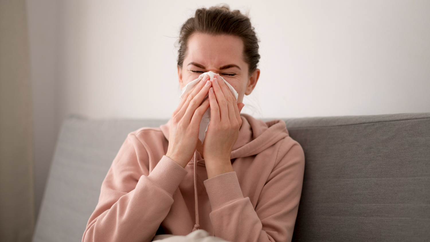 Person sneezing due to seasonal allergies, seeking relief from the best allergy doctor in Torrance, CA.