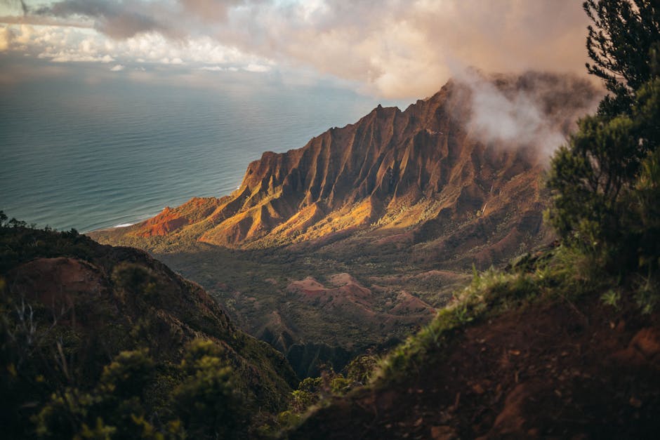 Napali Coast ridges glowing at golden hour above the ocean on Kauai