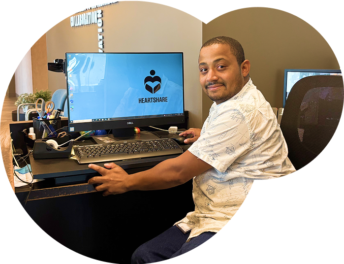 An individual on the computer in a Day Program computer lab