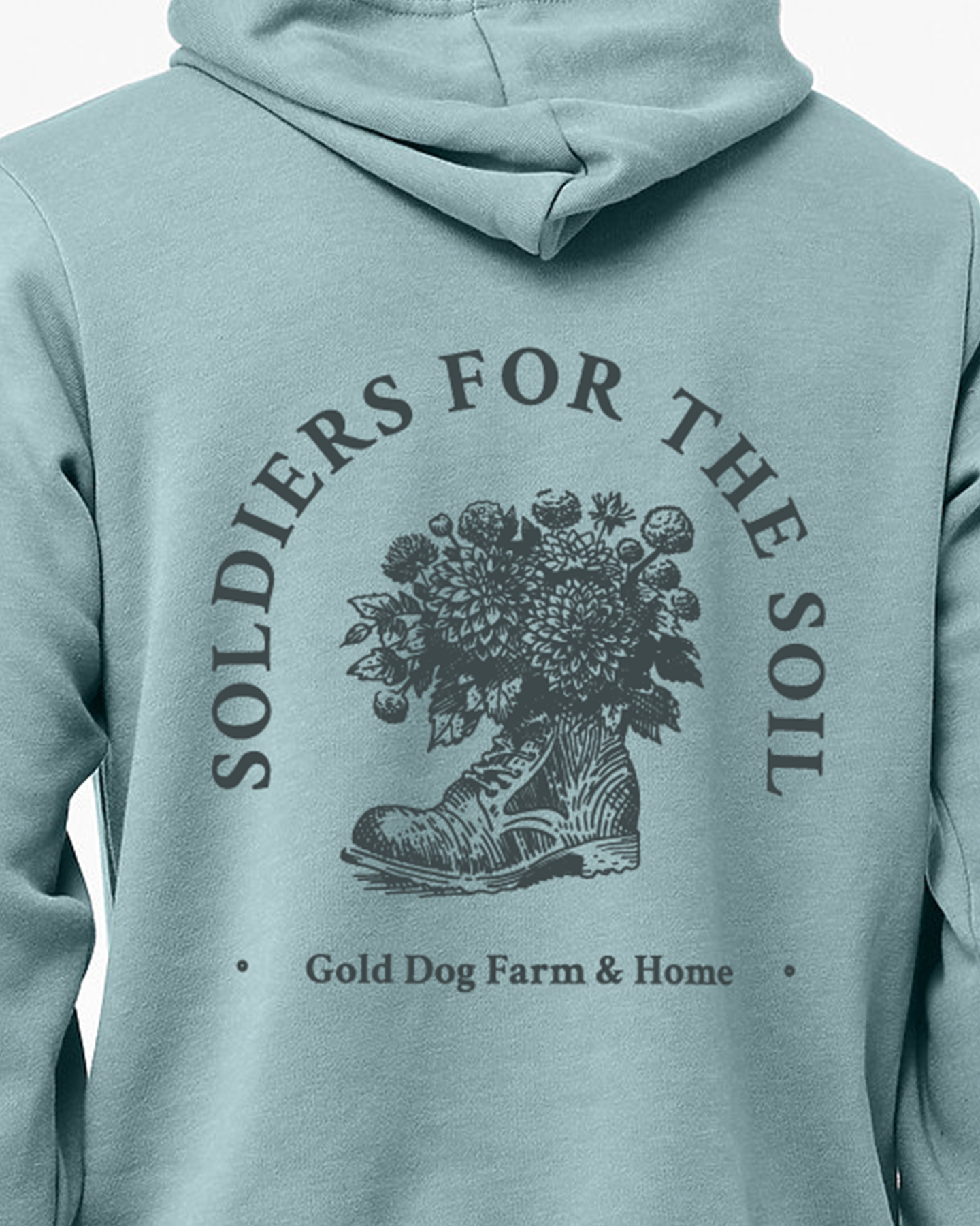 a hoodie mockup for gold dog farm with a boot holding flowers that reads soldiers for the soil