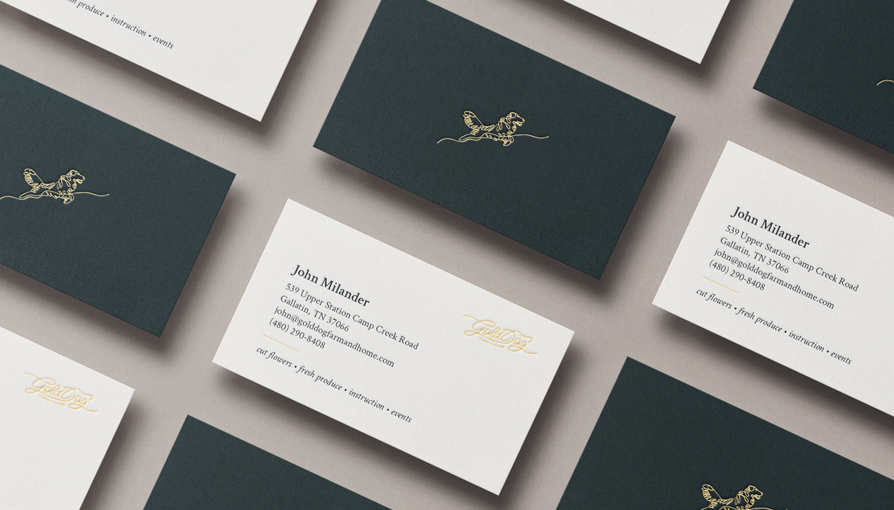 a mockup of business cards for gold dog farm and home