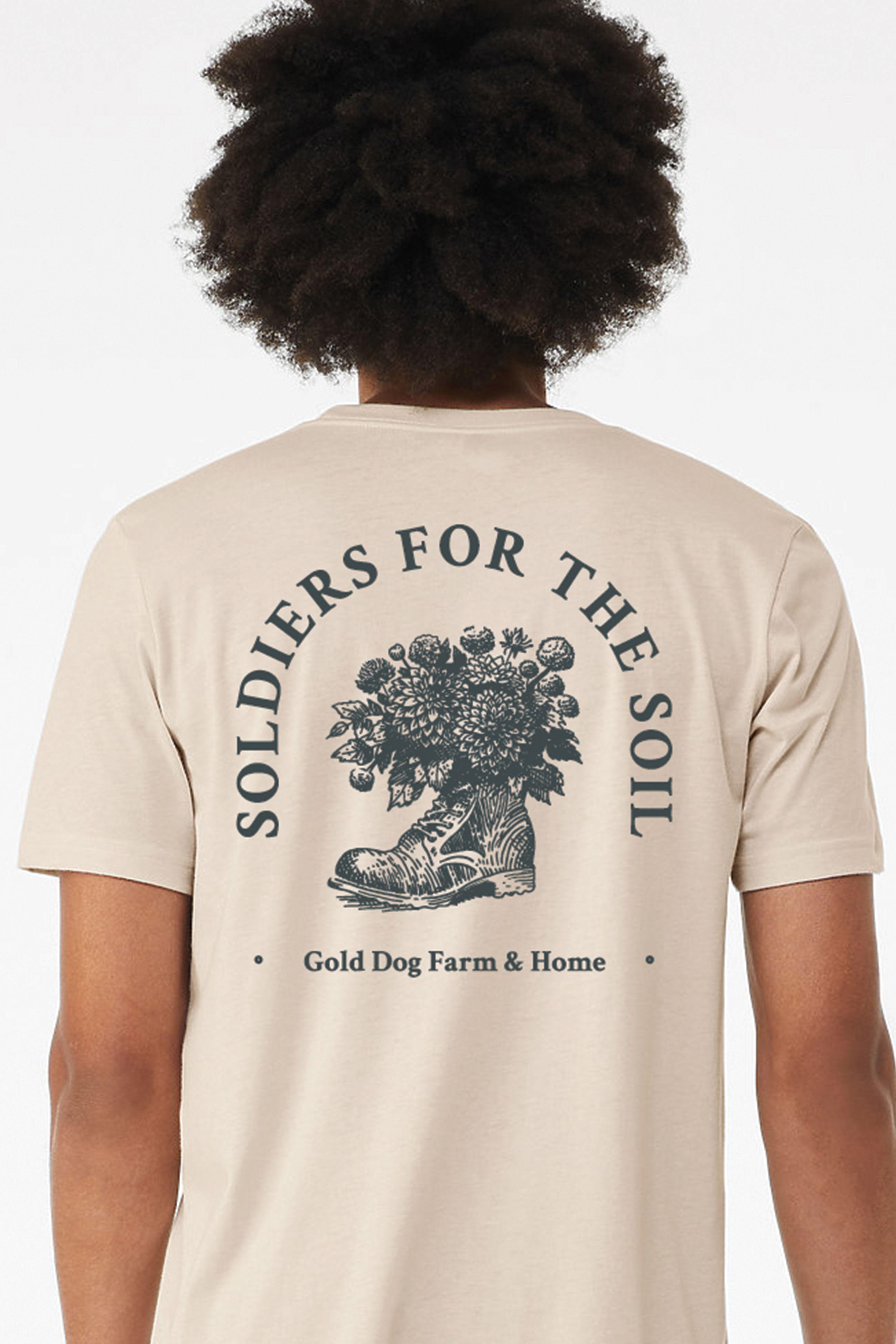 a tshirt mockup for gold dog farm with a boot holding flowers that reads soldiers for the soil