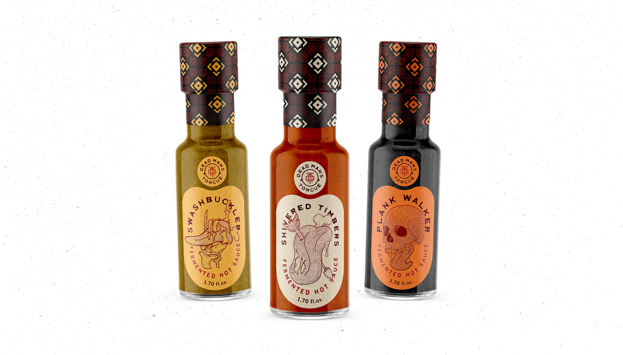 three hot sauce bottles designed by shawn tarr