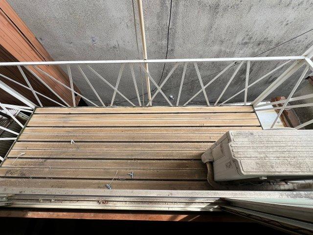 Outdoor wooden deck or balcony with metal railing