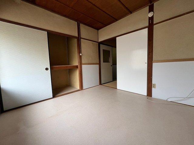 Empty room with traditional Japanese wall panels, wooden trim, and built-in storage