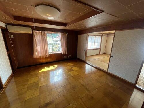 Rustic Wooden Living Area – Open space with aged wood interiors, ready for restoration.