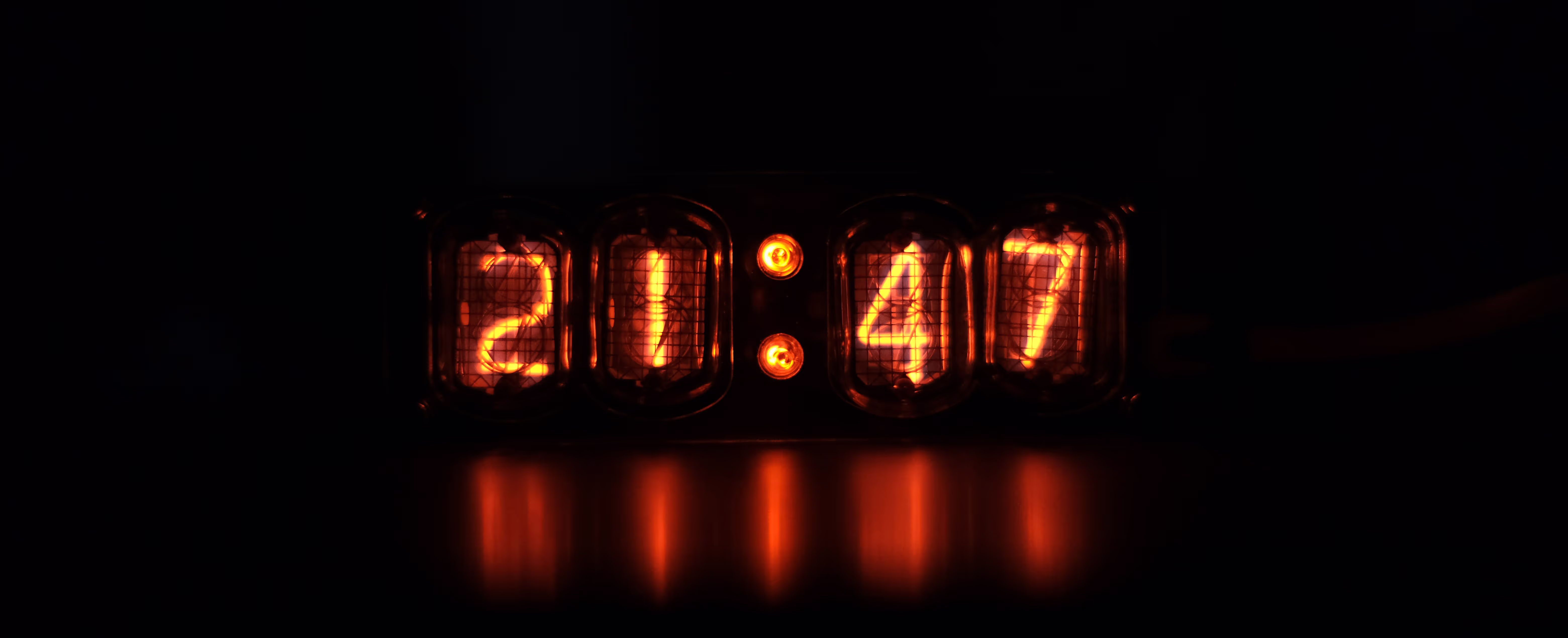 Orange digital clock with the time 21:47