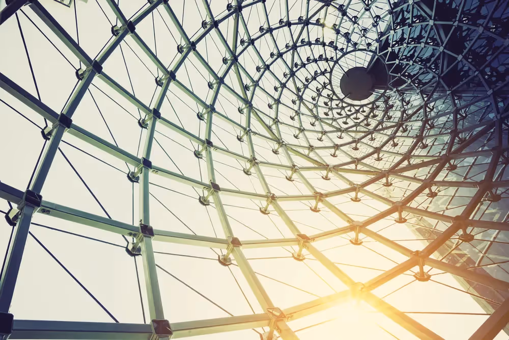 a ferris wheel with the sun shining through it