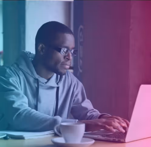 a man sitting at a table with a laptop