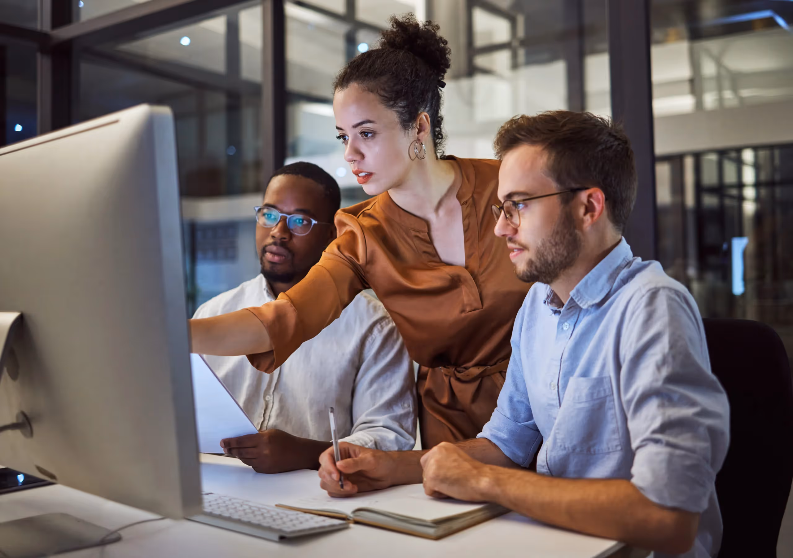 a man and woman looking at a computer screen